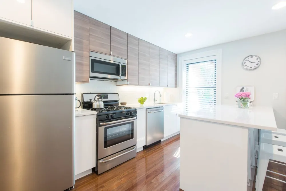 Modern kitchen with stainless appliances.