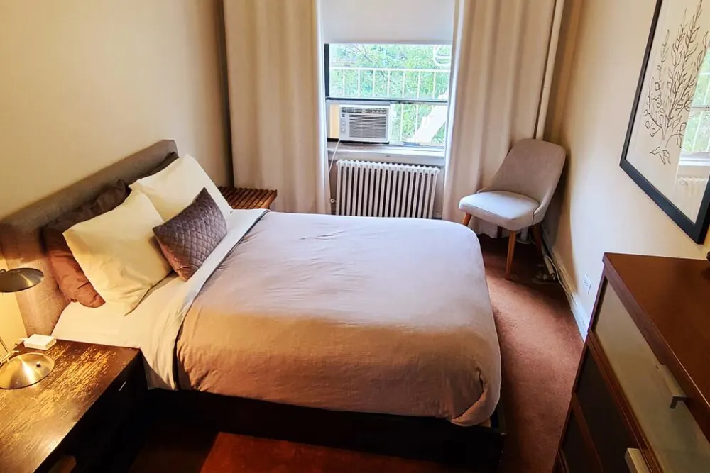 Cozy bedroom with window view.