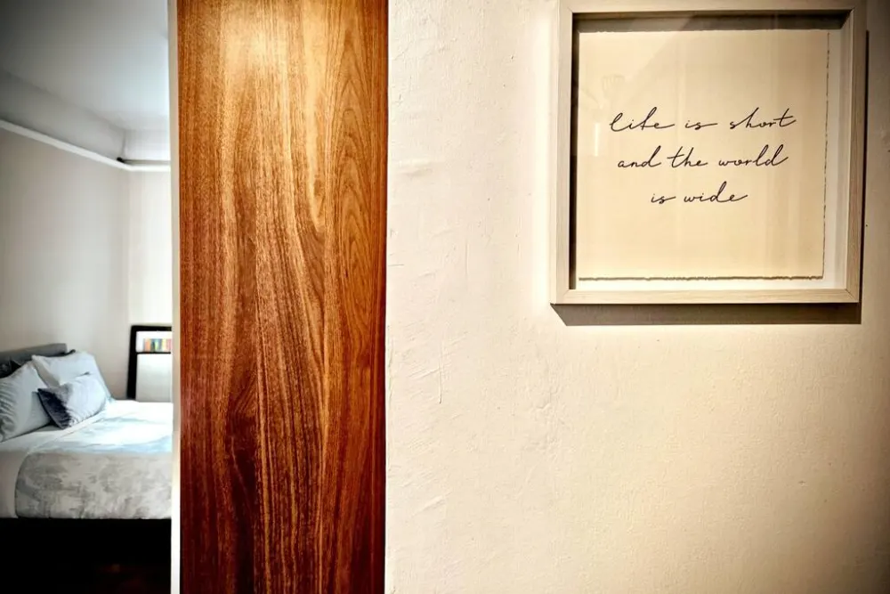 Cozy bedroom, inspiring wall quote.