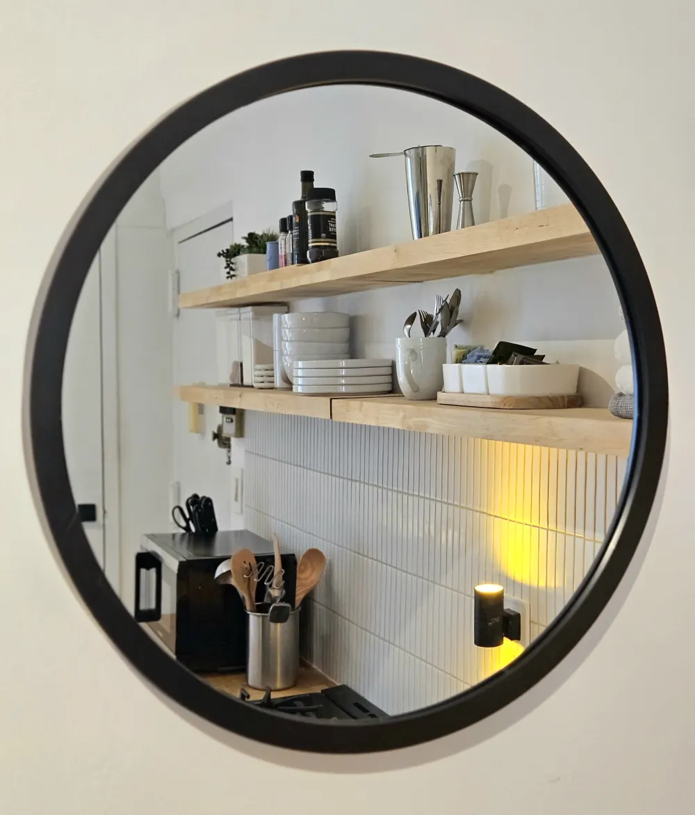 Modern kitchen reflected in mirror.