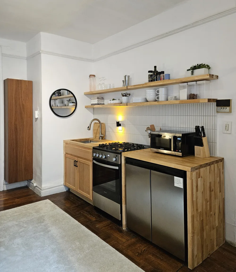 Modern compact kitchen with wooden accents.