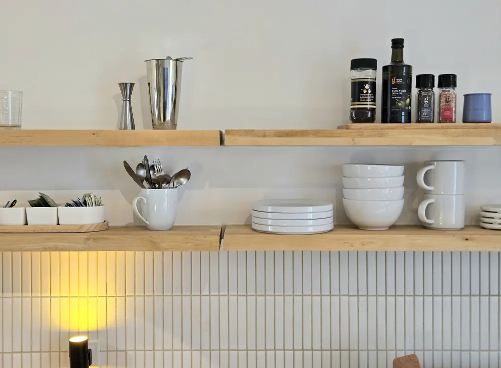 Wooden shelves with neatly arranged kitchenware.