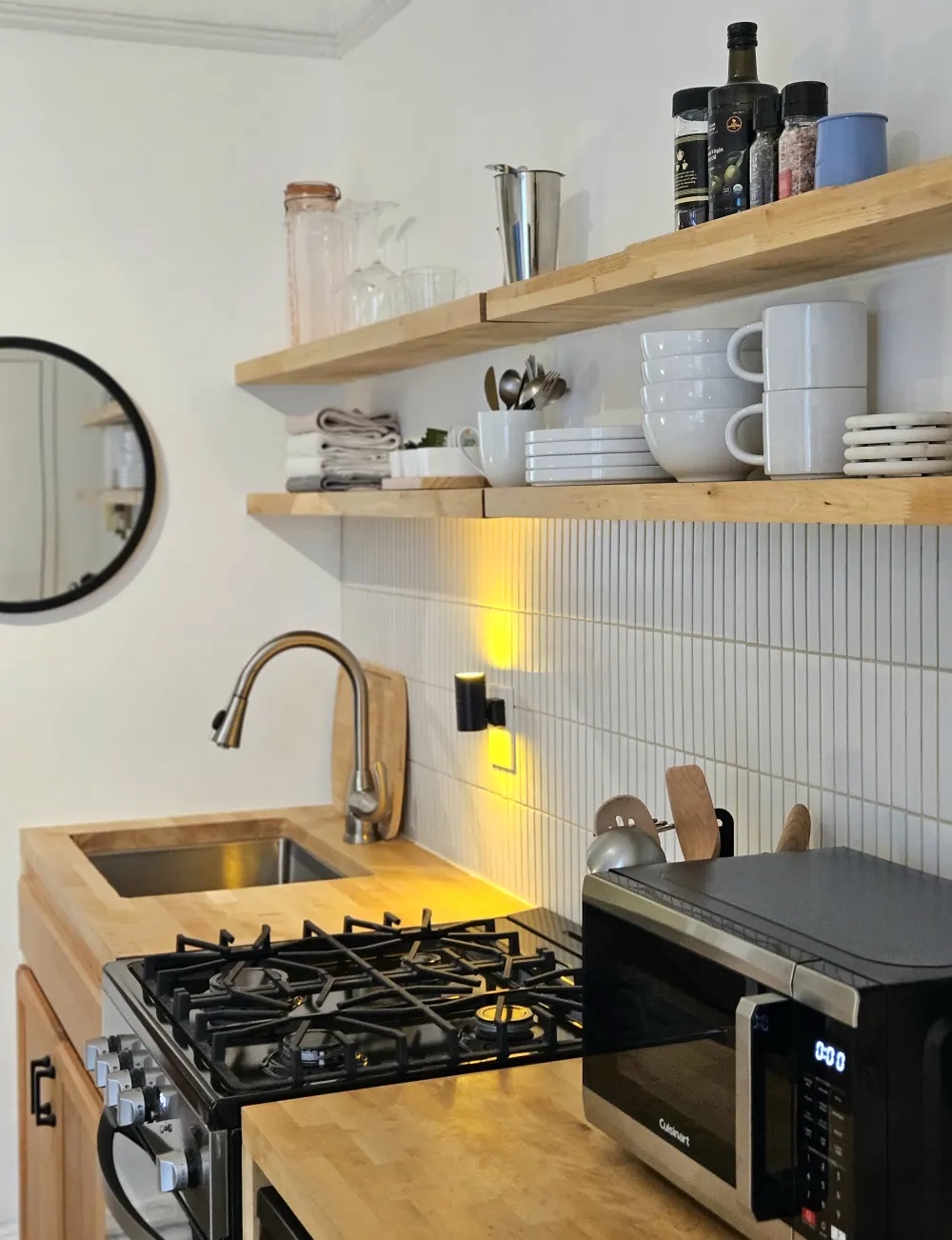 Modern kitchen with wooden shelves.