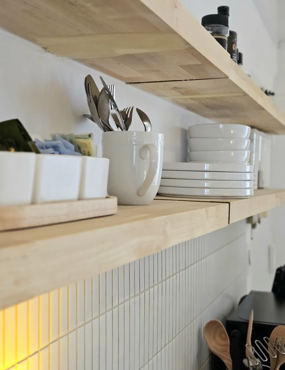 Minimalist open kitchen shelves, organized.