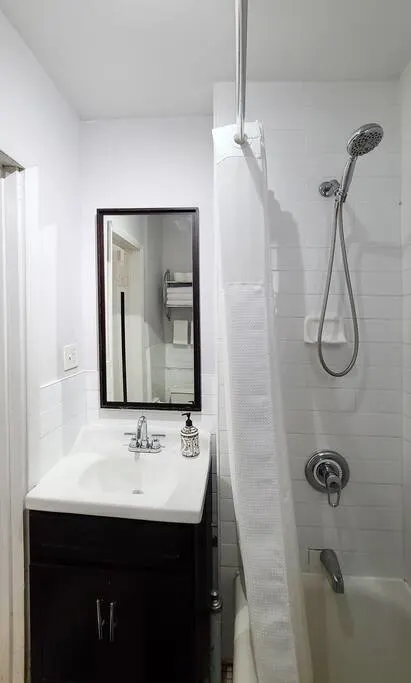 Clean compact bathroom with shower.