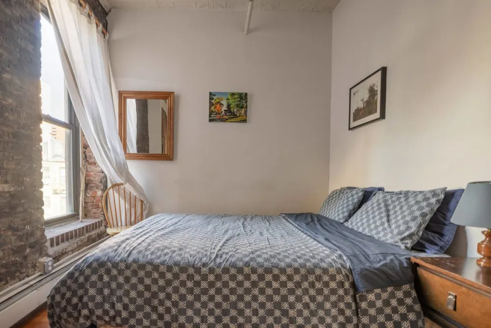 Cozy bedroom with brick accents.