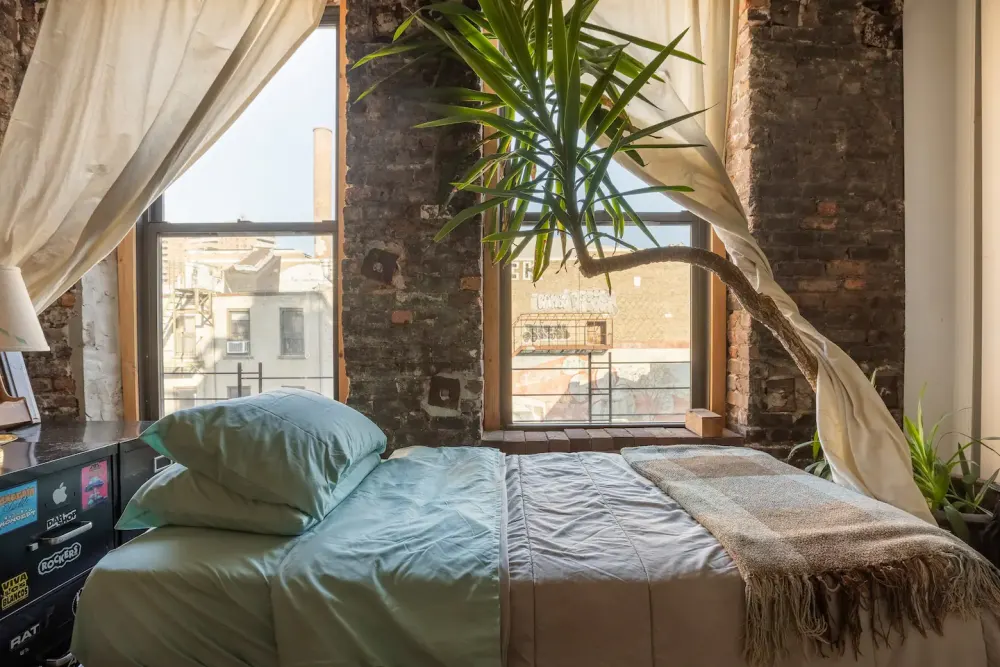 Cozy loft bedroom with plants.