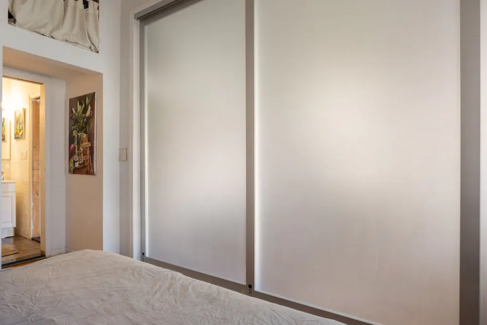 Cozy bedroom with bathroom entrance.