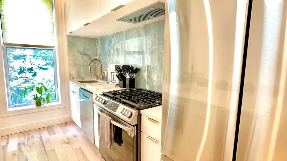 Modern kitchen with stainless steel appliances.