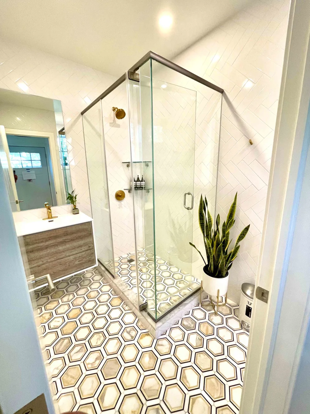 Modern bathroom with glass shower enclosure.