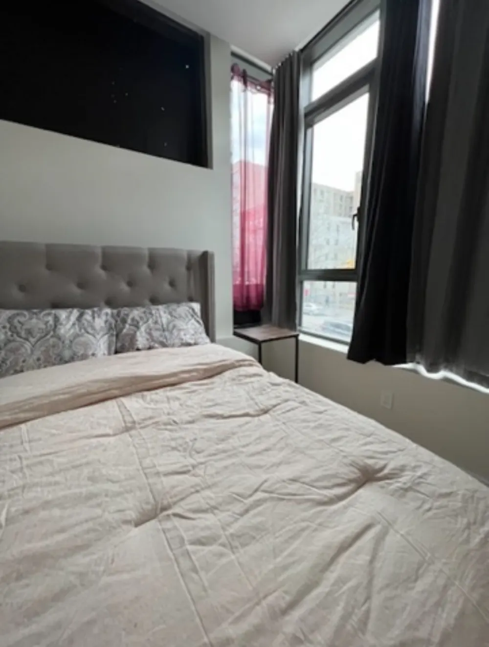 Cozy bedroom with large window.