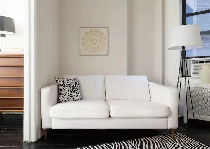 Modern white sofa with zebra rug.