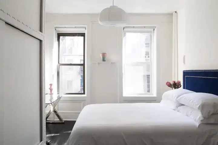 Bright minimalist bedroom with windows.