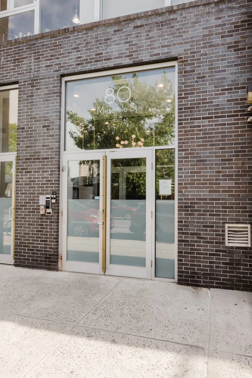 Modern glass entrance with address.