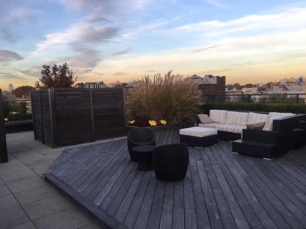 Modern rooftop patio at sunset.