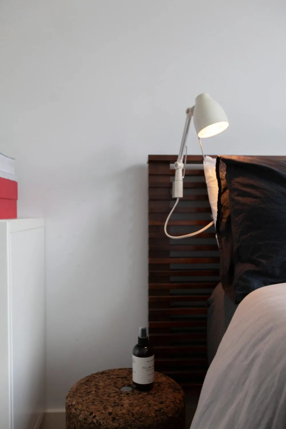 Minimalist bedside setup with lamp.