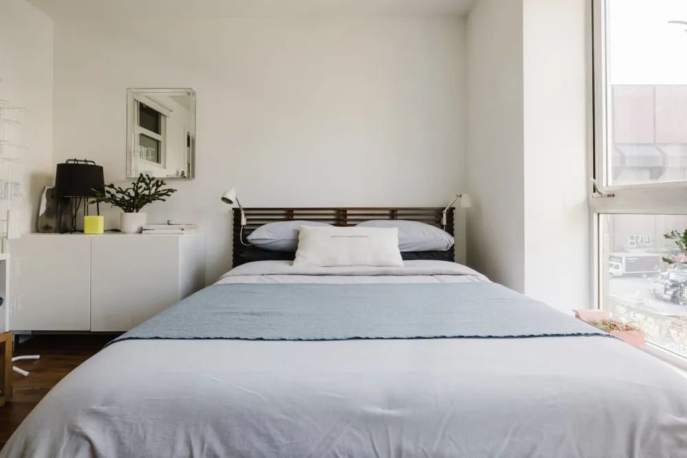 Bright minimalist bedroom with window.