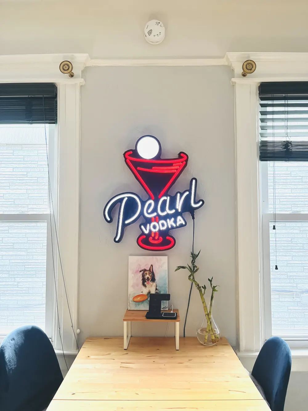 Neon sign above wooden table.