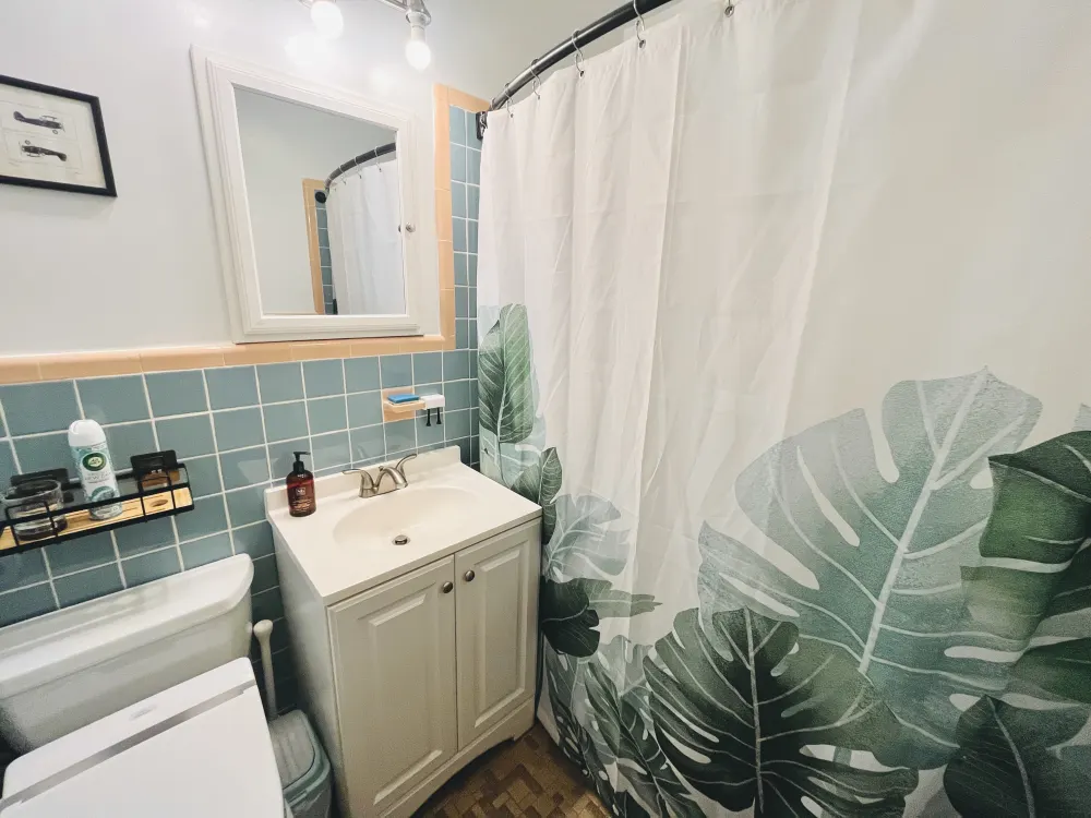 Bathroom with botanical-themed shower curtain.