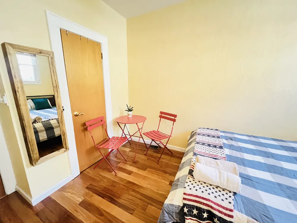 Cozy bedroom with red chairs.