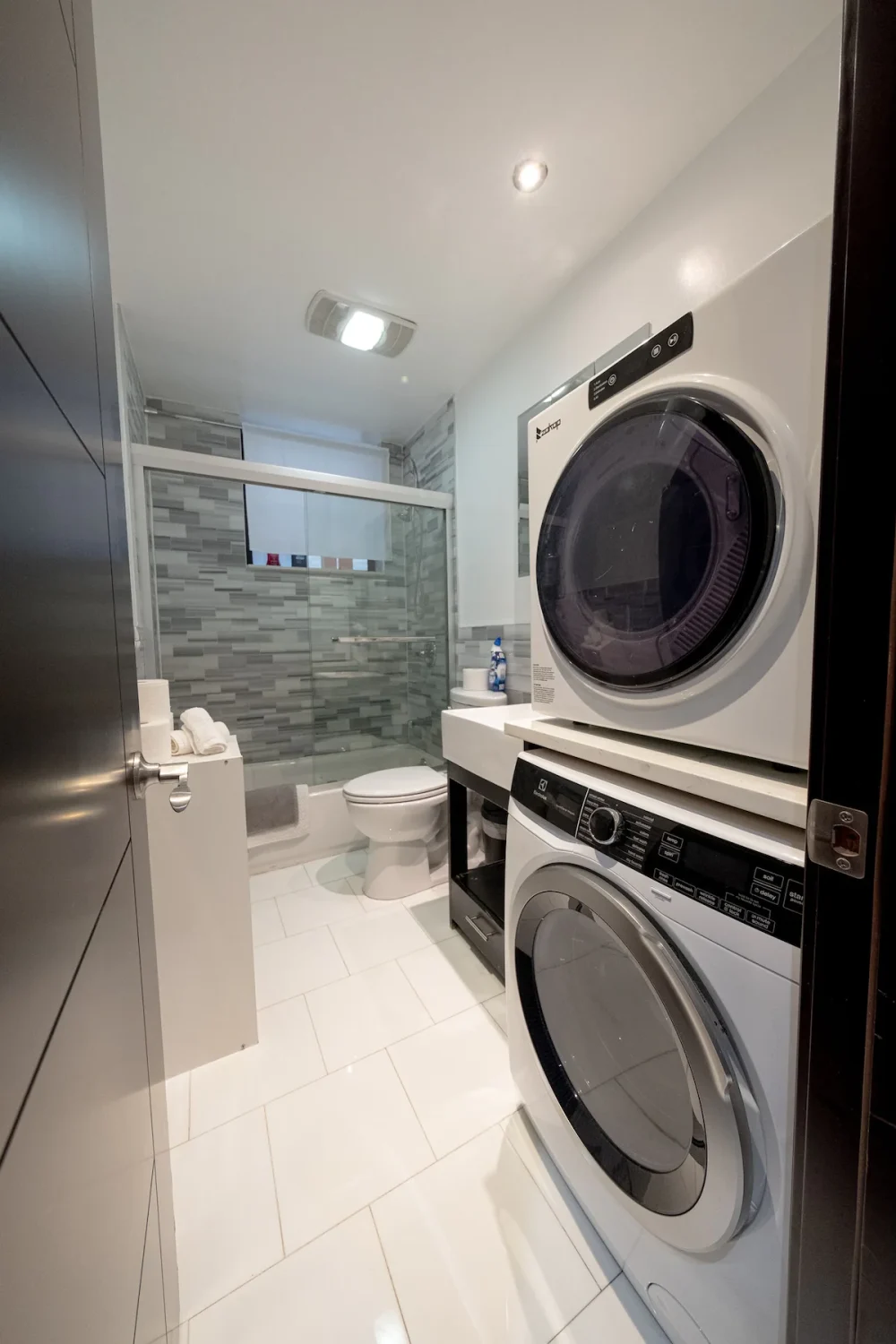 Modern bathroom with laundry machines.