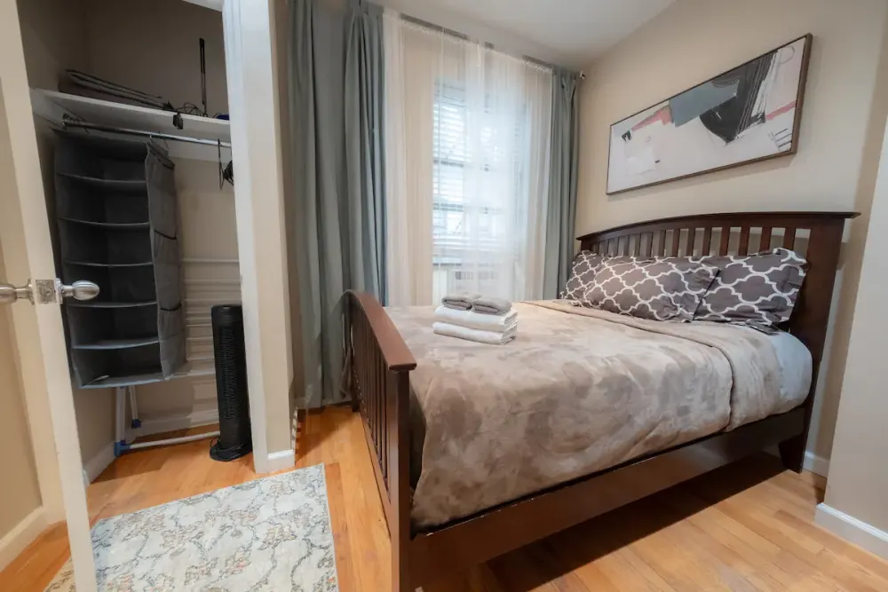 Cozy bedroom with wooden bed.