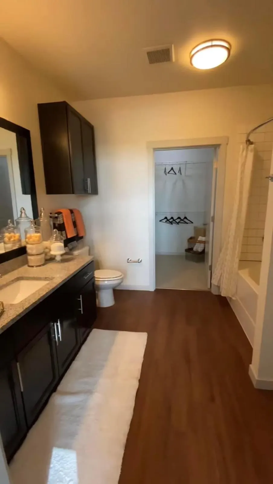 Modern bathroom with wooden flooring.