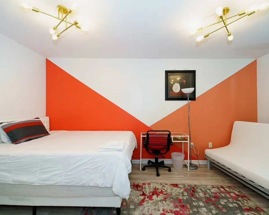 Modern bedroom with geometric accent wall.