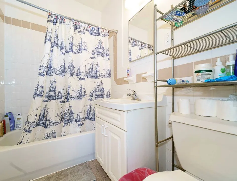 Bright bathroom with nautical shower curtain.