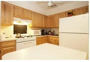 Cozy kitchen with wooden cabinets.