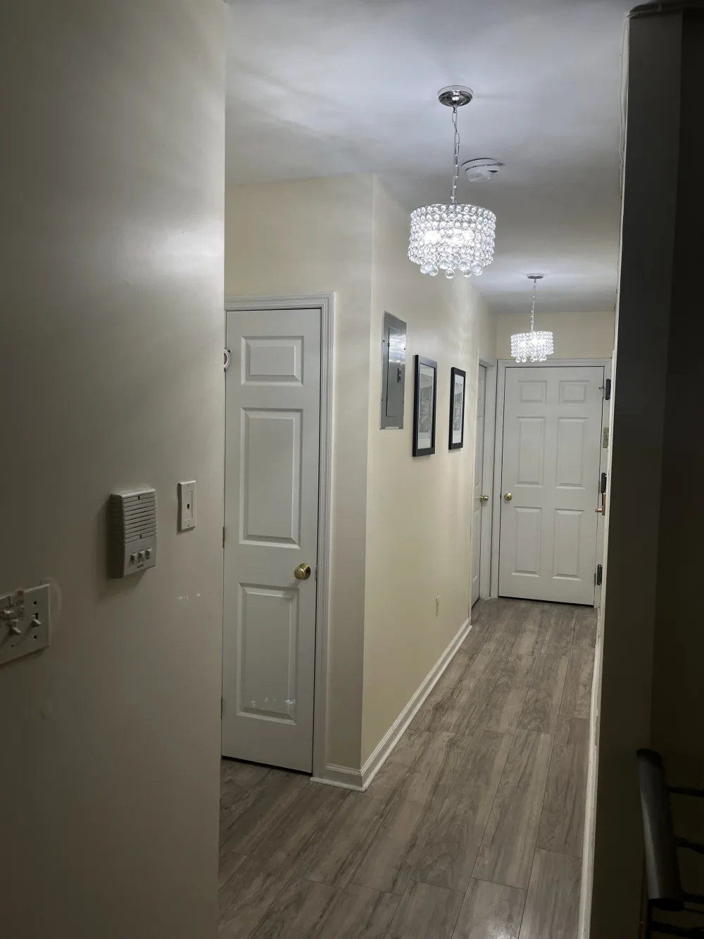 Modern hallway with crystal chandeliers.