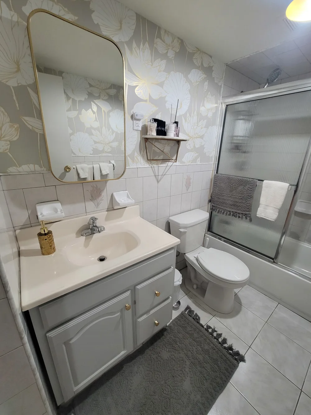 Modern bathroom with floral wallpaper.