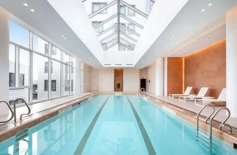 Indoor pool with lounge chairs.