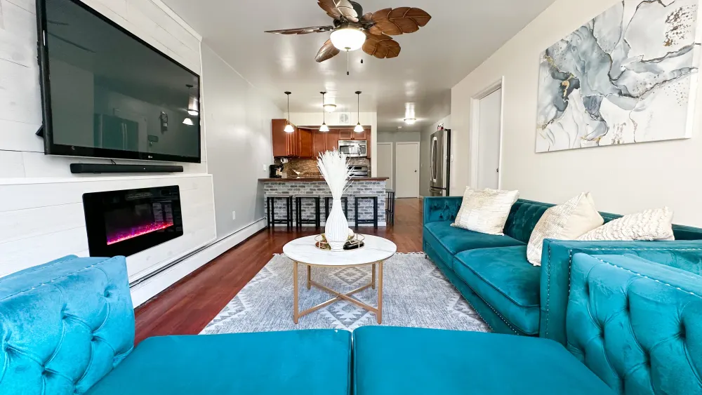 Modern living room with teal sofas.