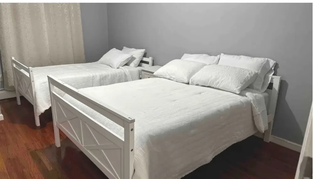 Two twin beds, white decor.
