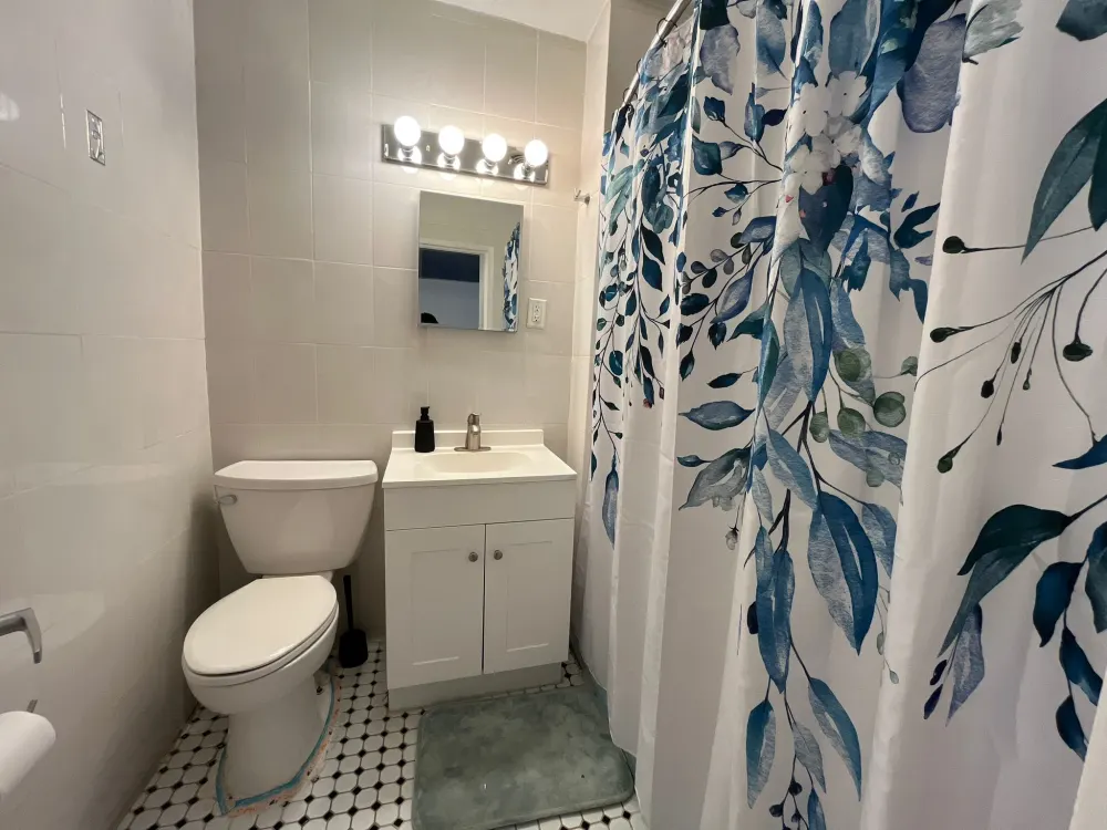 Bathroom with floral shower curtain.