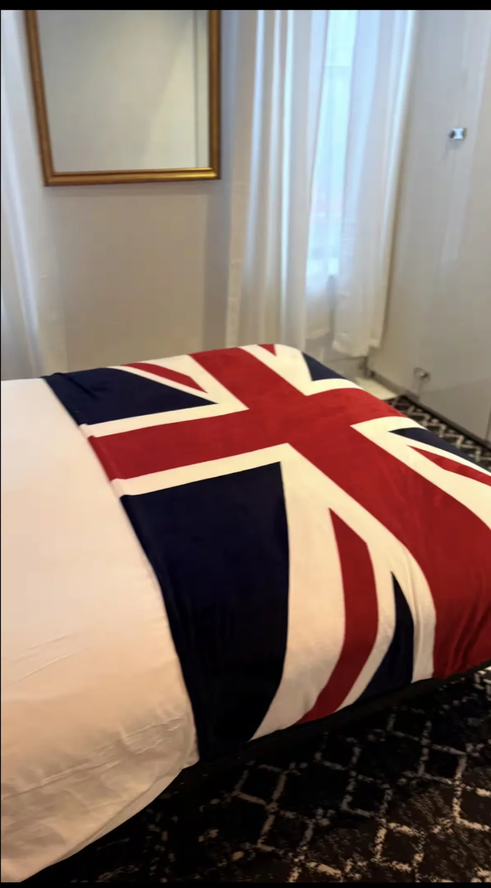 Union Jack blanket on bed.