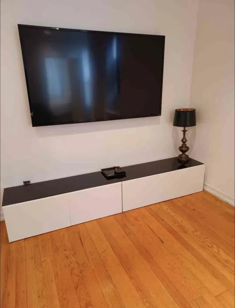 Modern TV setup, wooden floor.