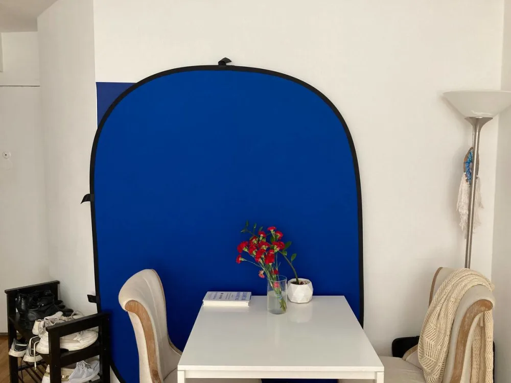Cozy dining area, blue backdrop.