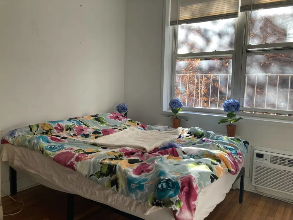 Bright room with floral bedding.