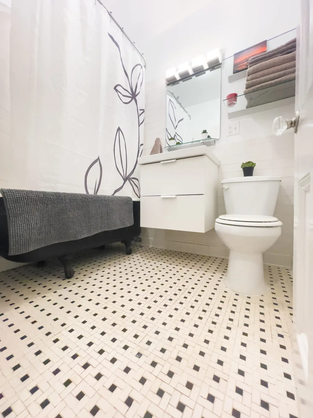 Bright bathroom with patterned floor.