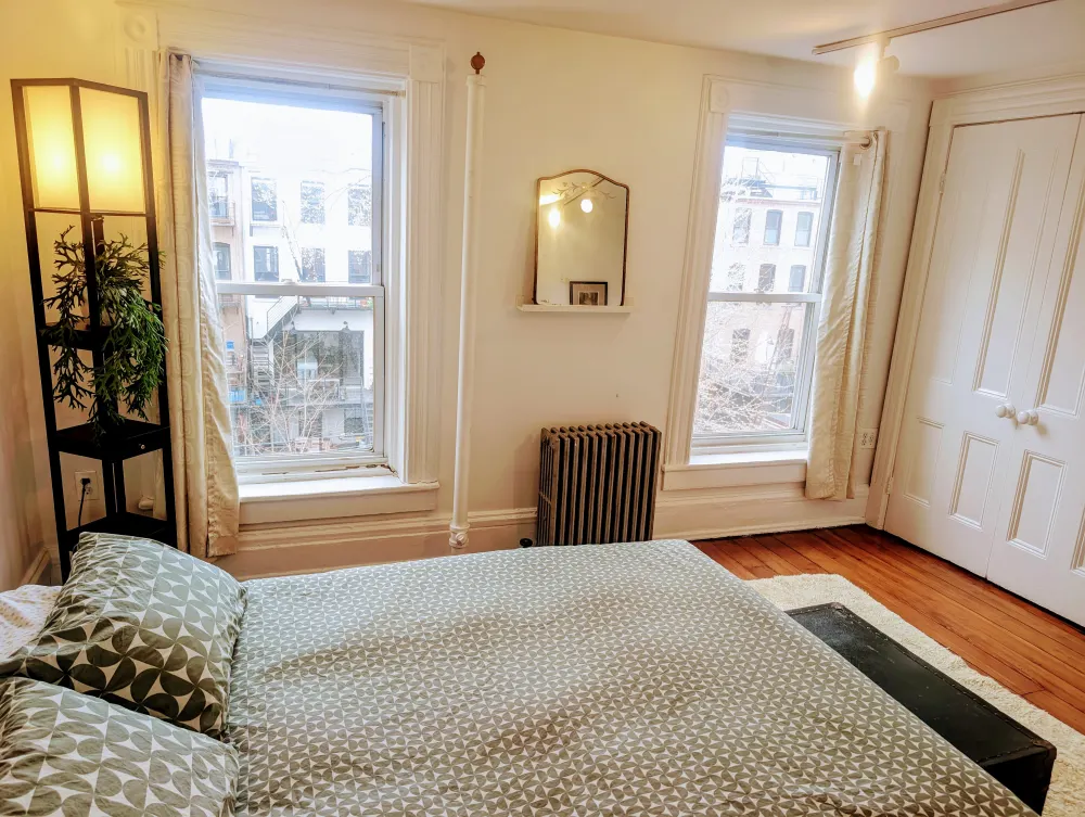Bright bedroom with large windows.