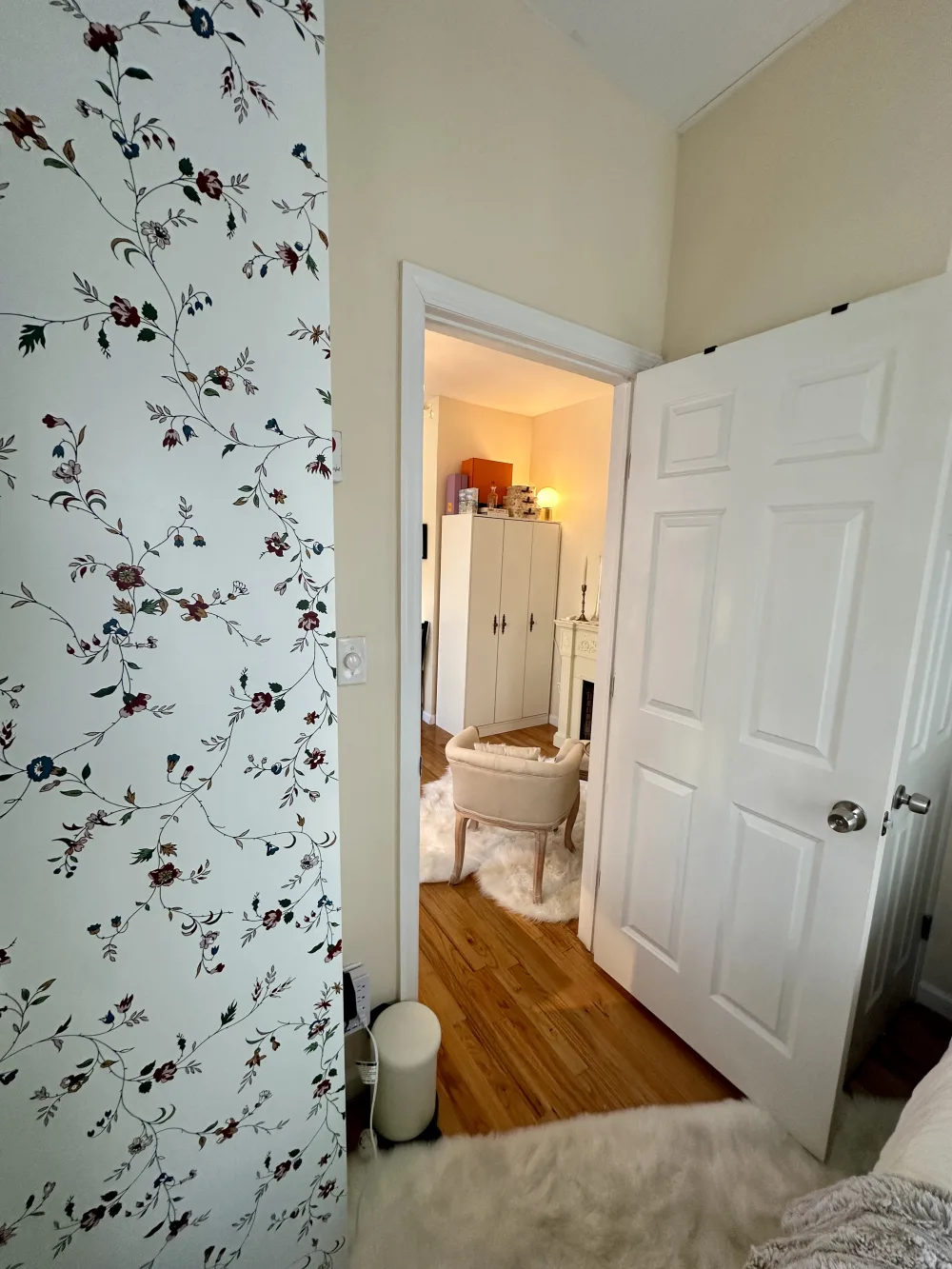 Cozy room with floral wallpaper.