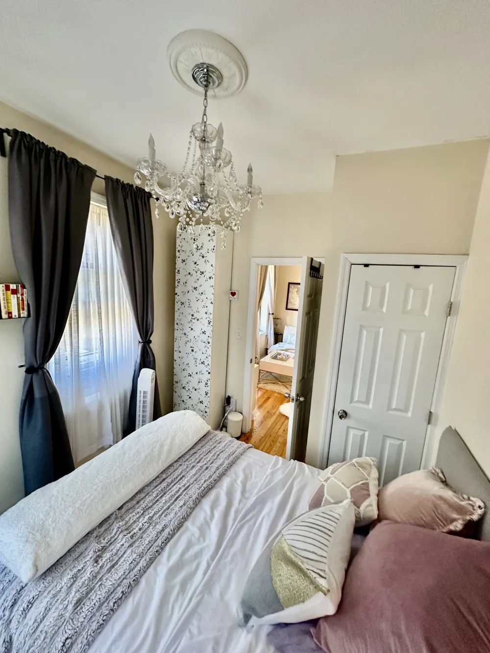 Cozy bedroom with elegant chandelier.