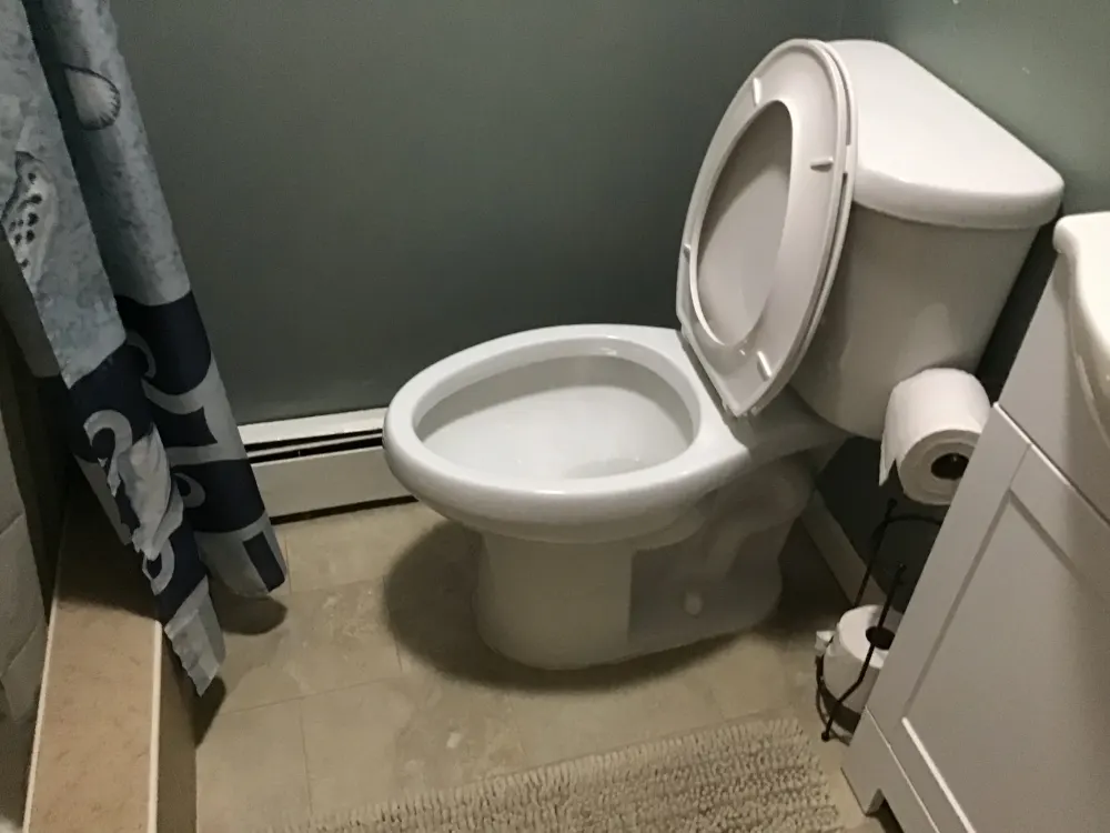 Clean bathroom with toilet visible.