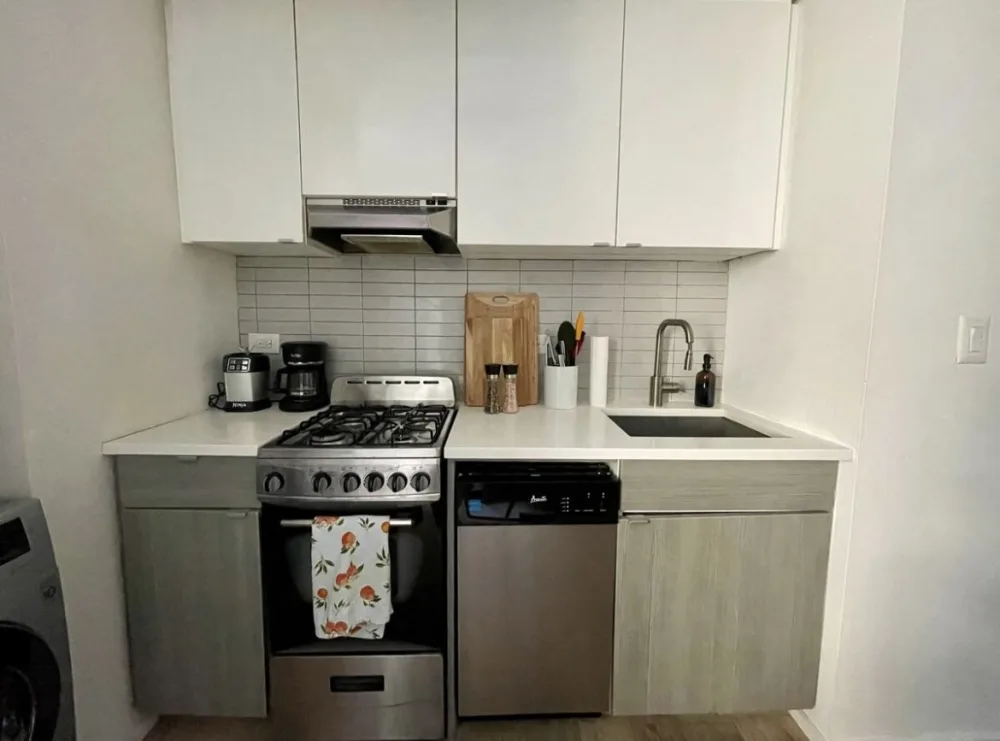 Modern compact kitchen with appliances.