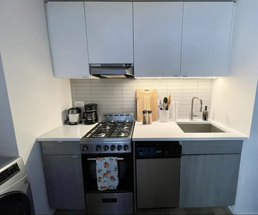 Modern compact kitchen with appliances.