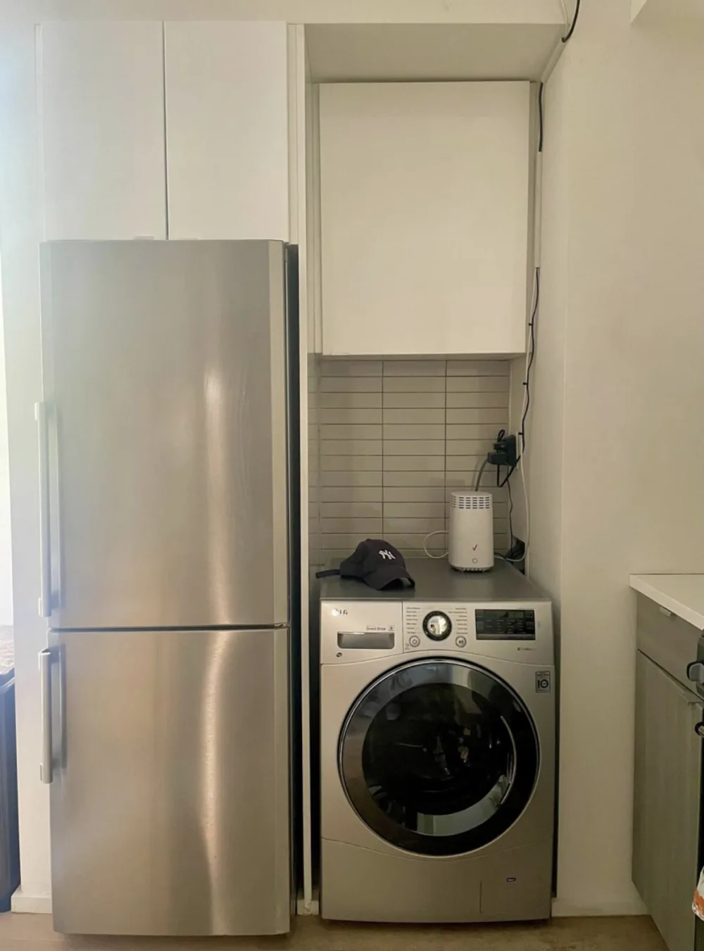 Modern kitchen with washer, fridge.