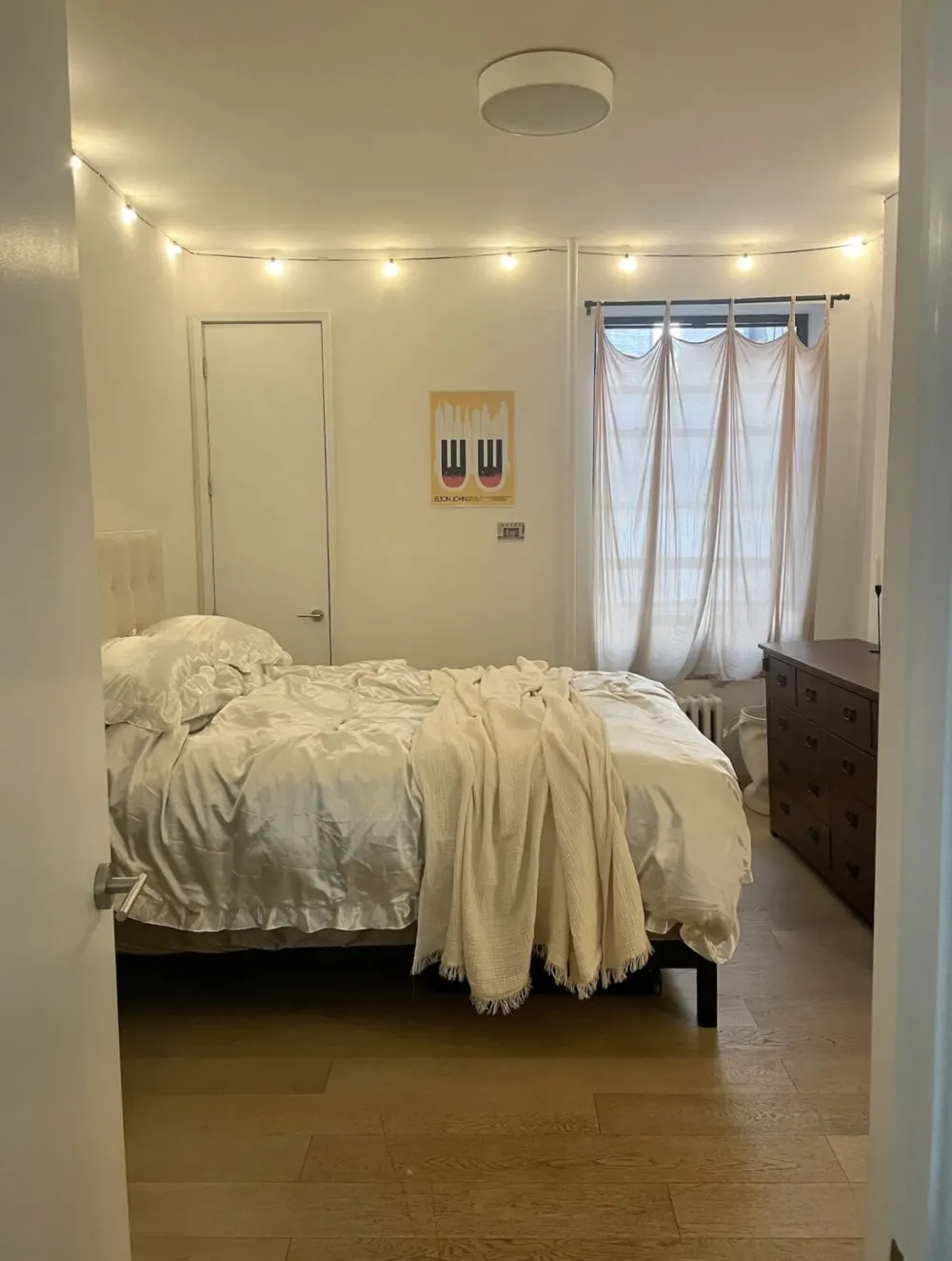 Cozy minimalist bedroom with lights.