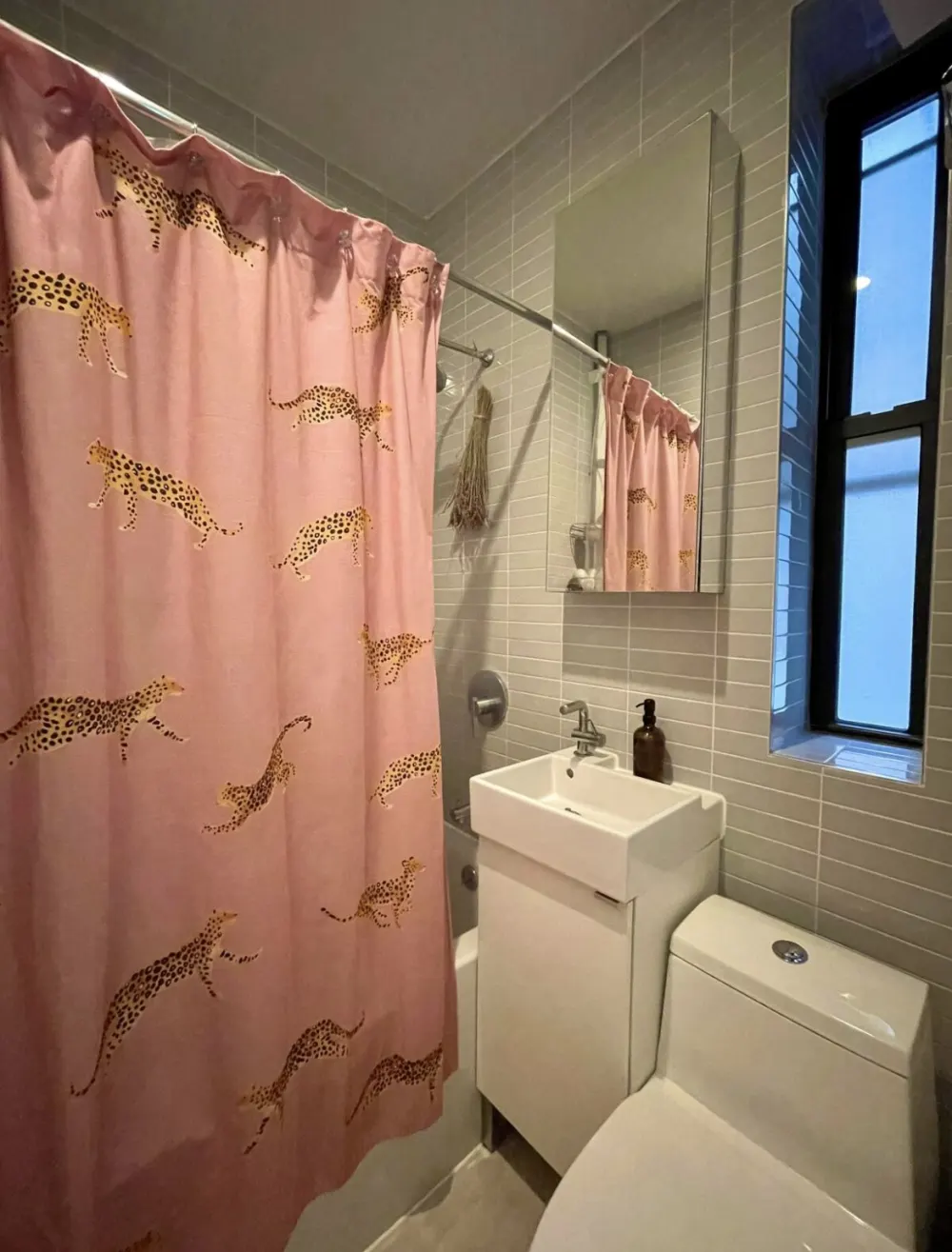 Modern bathroom with pink cheetah shower curtain.